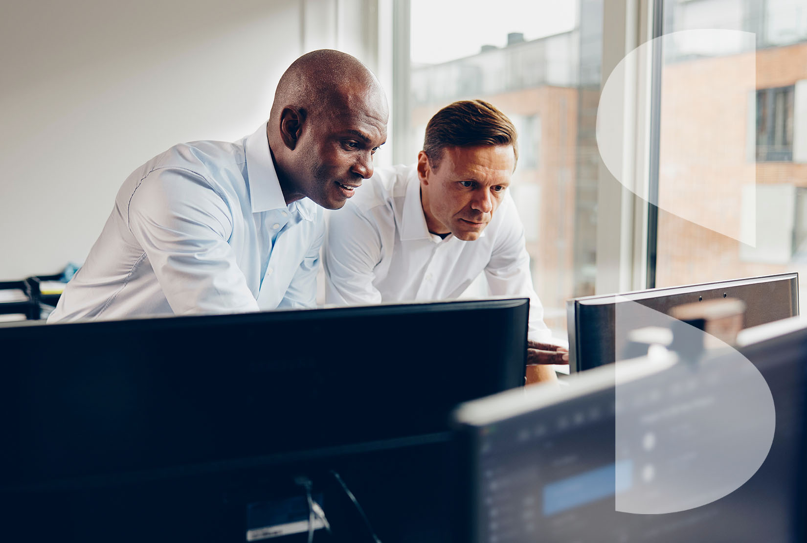 two professional adult men using computers