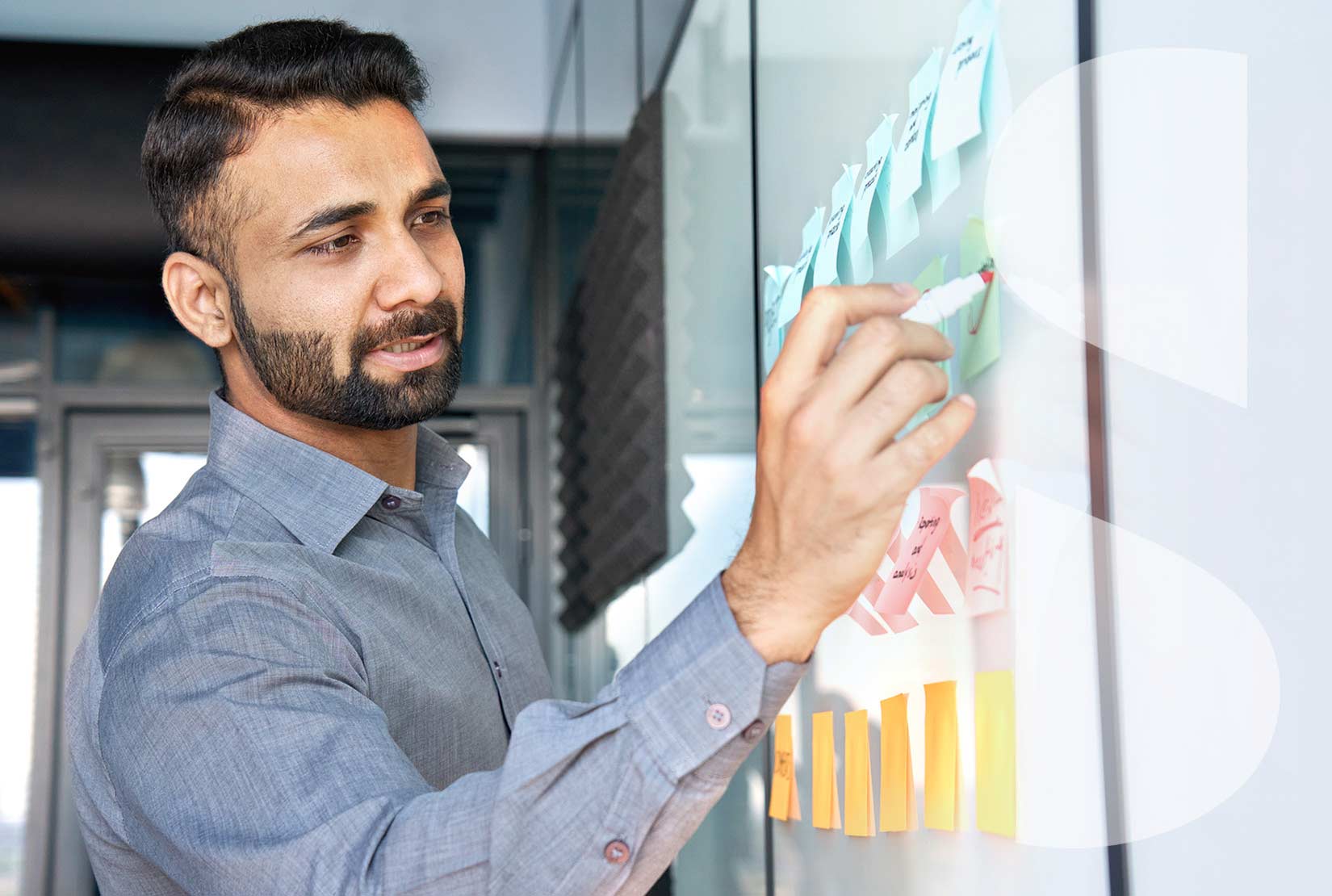 a professional man writing on a whiteboard