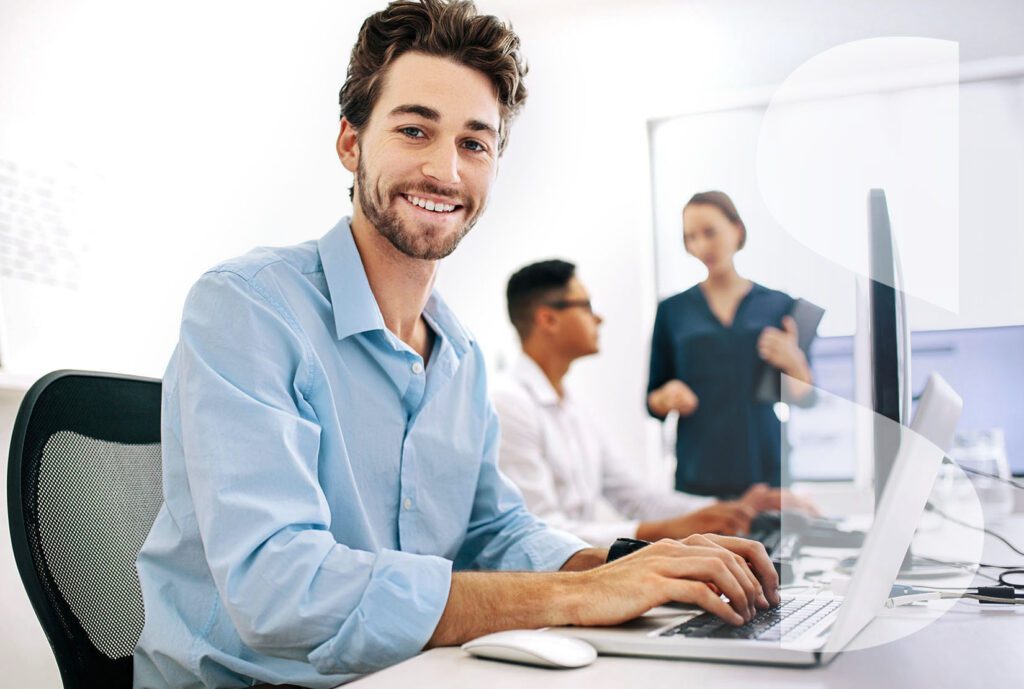 a group of professional people using computers in an office